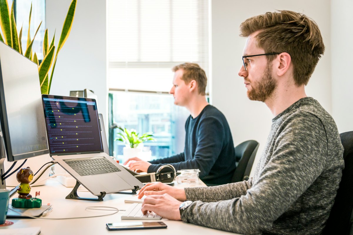A team working together around screens in a bright office